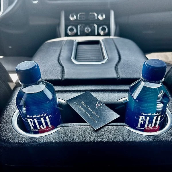 Inside of an black SUV limo with a business card of Miami Limo Car