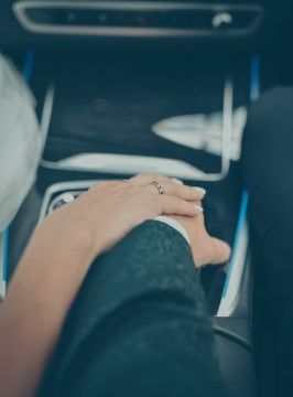 Bride and groom holding hands in a limousine